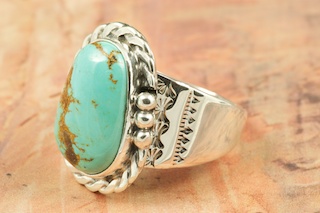 Genuine Royston Turquoise set in Sterling Silver Ring. Beautiful Matrix in this Turquoise Stone. The Royston Turquoise Mine is located in Nye County, Nevada. Created by Navajo Artist Tony Garcia. Signed by the artist.